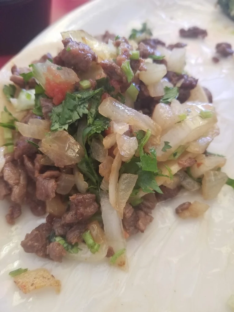 Beef Fajita Taco - Sizzling grilled beef fajita strips served in a warm tortilla with grilled onions, bell peppers, and your choice of toppings.